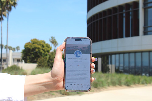Hand holding a phone that is open to the platform of Zeemee